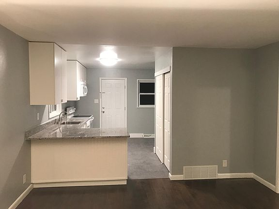 Open concept kitchen and living room. Back door from kitchen