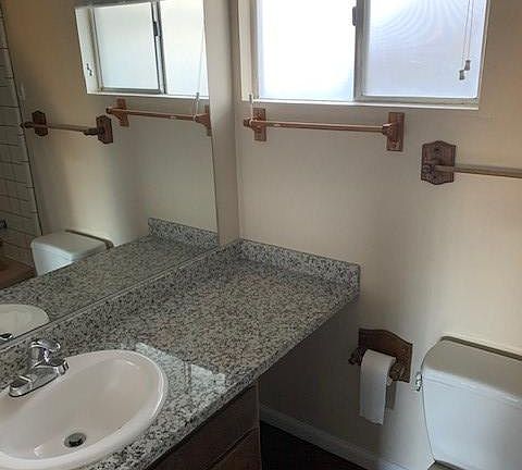 Granite counters and new mini blinds in the bathroom.