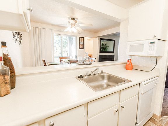 Tacoma Apartments - The Lodge at Madrona Apartments - Kitchen, Dining Room, Fireplace, and Living Room