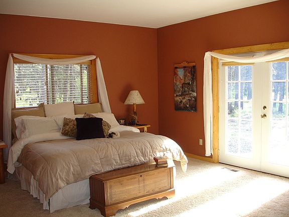 Huge master bedroom features french doors that open to beautiful back patio.