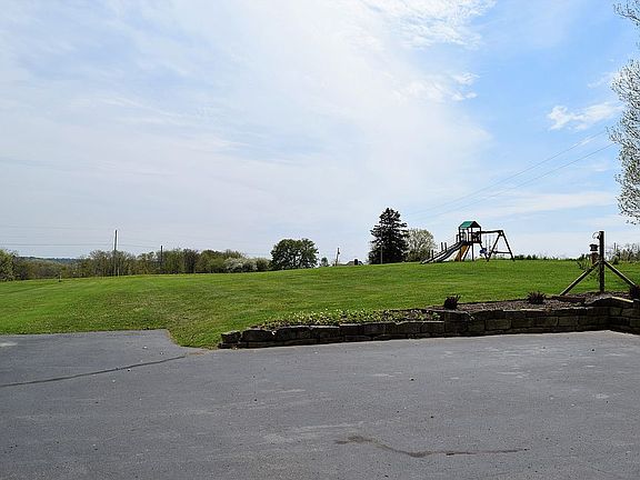 Paved driveway and backyard.