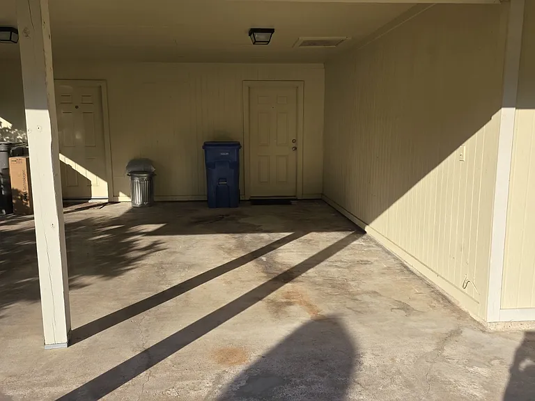 Carport parking with entrance to private laundry area.