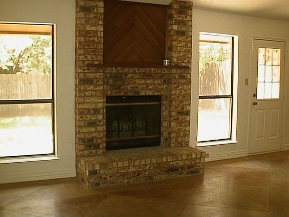 Decorative Brick Woodburning Fireplace in Large Living Area!