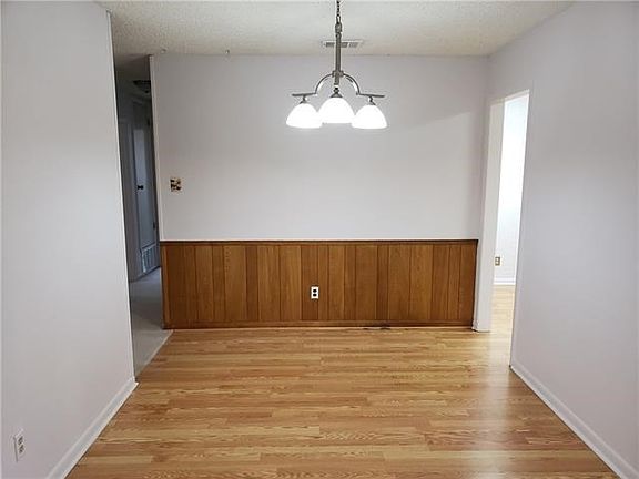 Formal dining room with laminate wood flooring.
