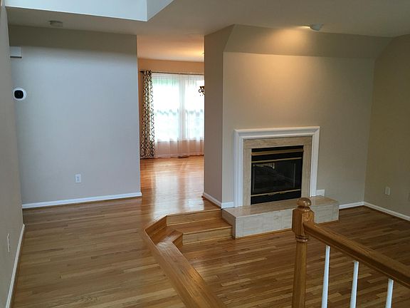 Entrance with double-sided gas fireplace between the dining room and formal living room