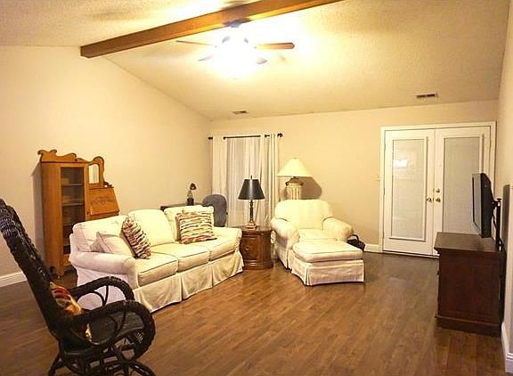 Great Room from the entry foyer. Note the newer laminate floors and wide baseboard. French Doors at right lead to the screened Florida Room.