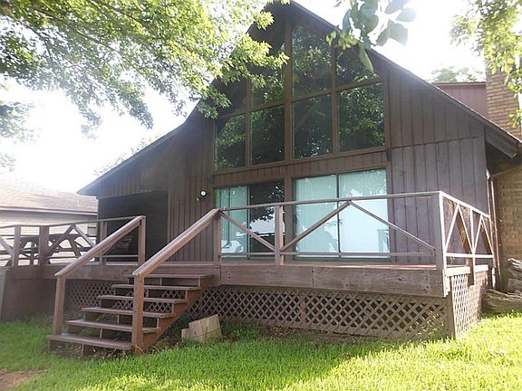 View from the back of the home with a large deck to take entertaining out side.