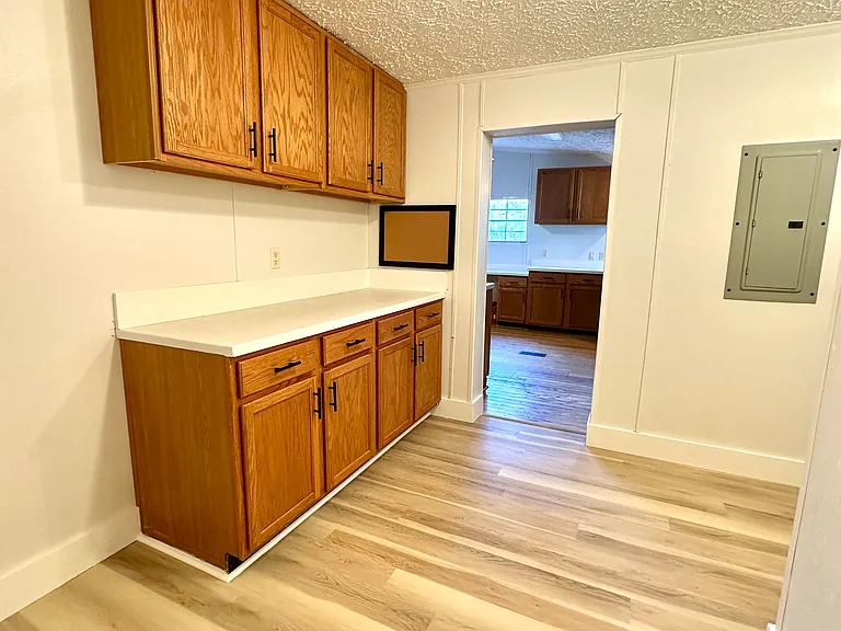 This house has a great "mud room" that comes off the side porch. Washer and dryer are in the mud room, with lots of cabinetry and a nice, redone countertop.
