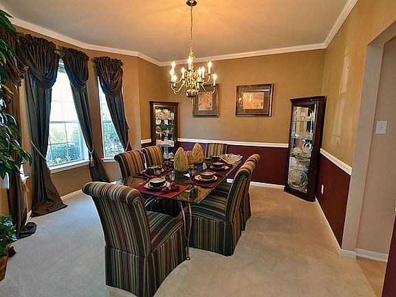 As you enter the foyer there is the formal dining room with wonderful accent color and great space.