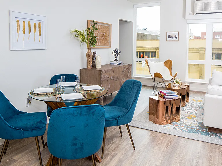 Dining area with plush seating and natural light for a welcoming vibe.