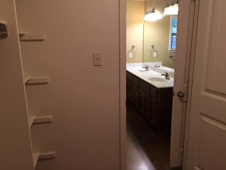 From walk in closet into bath