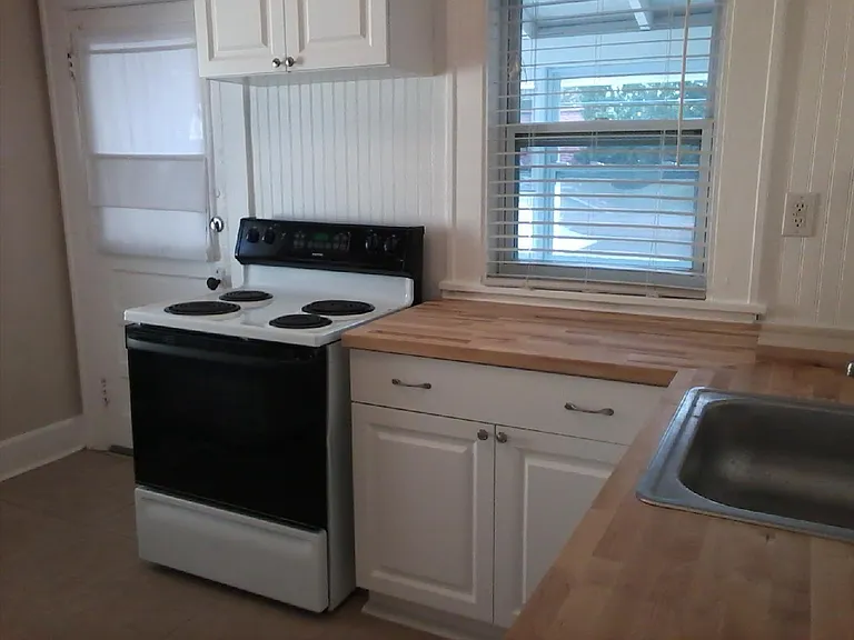 electric stove...door leads to back porch and the 2nd entrance.