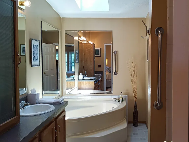 2 sinks, shower, 54" x 54" corner tub, closet filled with towels