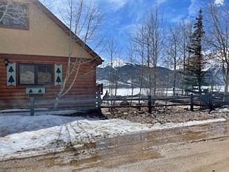 View of ranch style home; aspen grove next to home; lower level parking west
side of home.