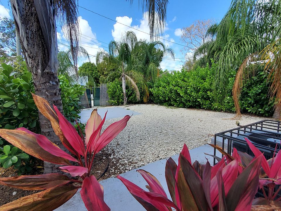 Fenced gated garden area for parking, entertaining. Additional parking available.