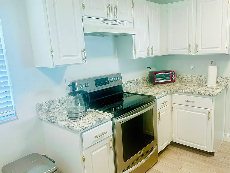 Lots of cabinets. New stove. New quartz countertop.