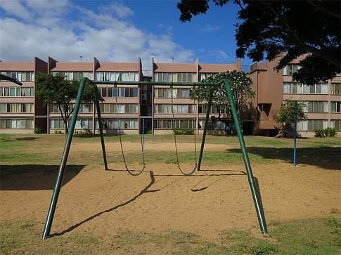 Courtyard has swings and play equipment for residents use.