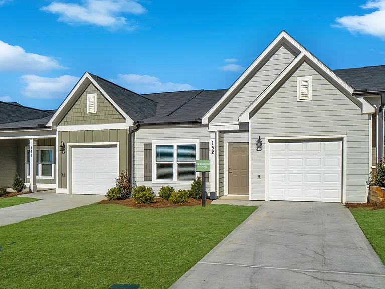 Exterior of the Richmond, ranch-style cottage home with a private driveway and attached garage.