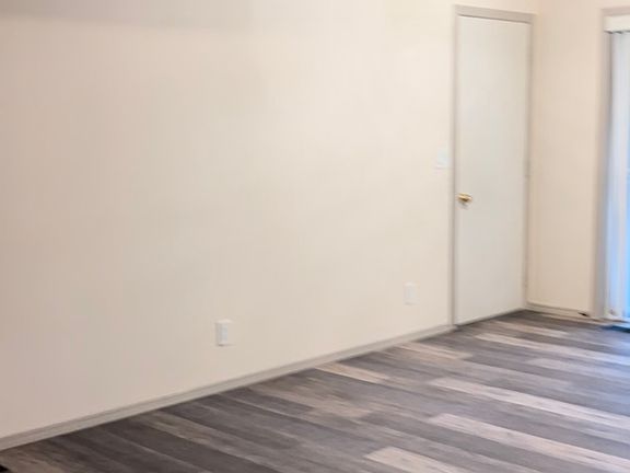 Dining area between living room and kitchen entry. (Door on left is to the garage).
