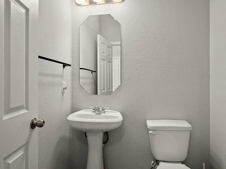 HALF-BATH CONVENIENTLY LOCATED OFF THE KITCHEN / LIVING AREA
