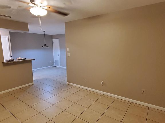 Living room looking towards dining area. Front door is on left side.