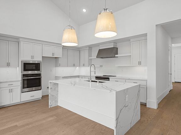 Kitchen with spacious island and stainless appliances