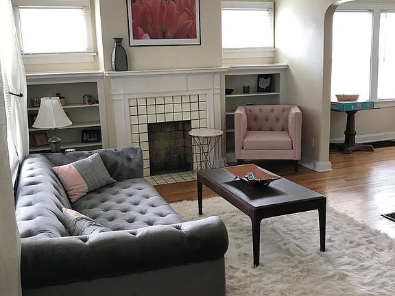 living room with fireplace and refinished hardwood floors