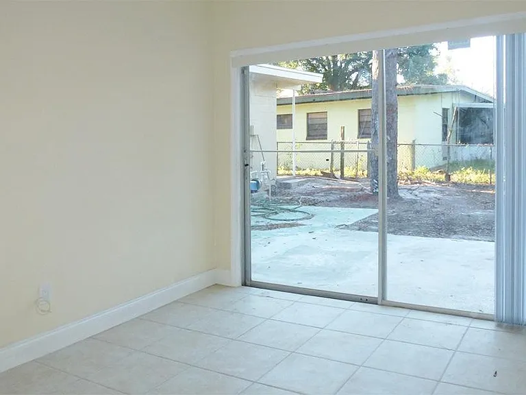 4th bedroom with patio door to rear patio