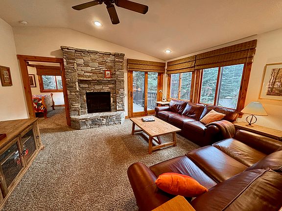 Great room filled with windows set around BIG trees