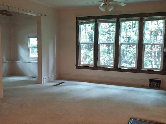 Large, spacious living room with tall windows offering lots