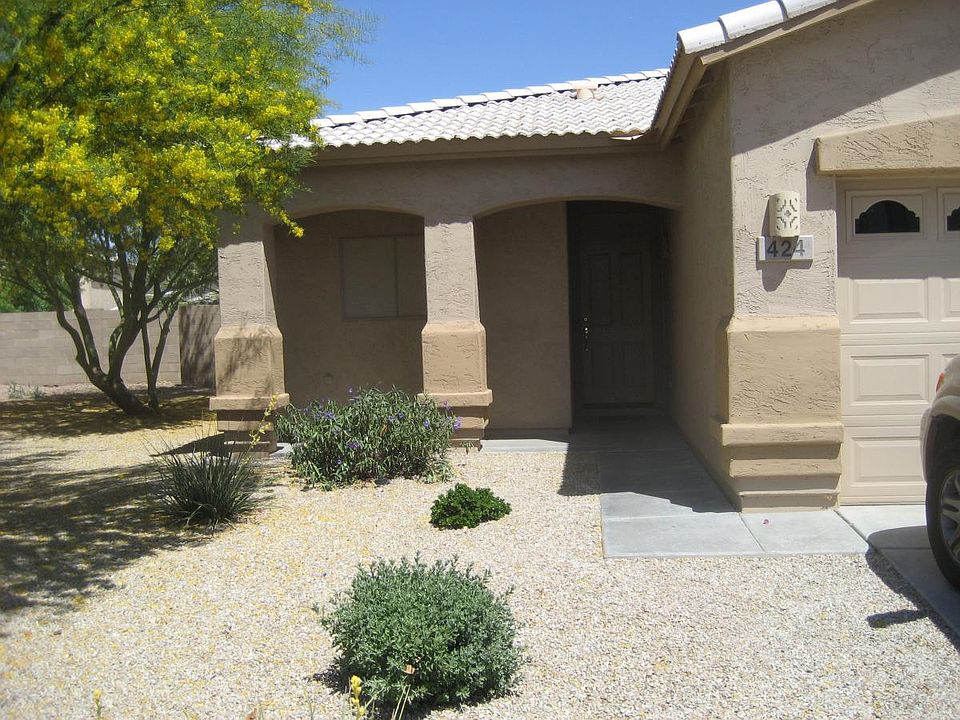 View of front with two gorgeous flowering palo verde trees.