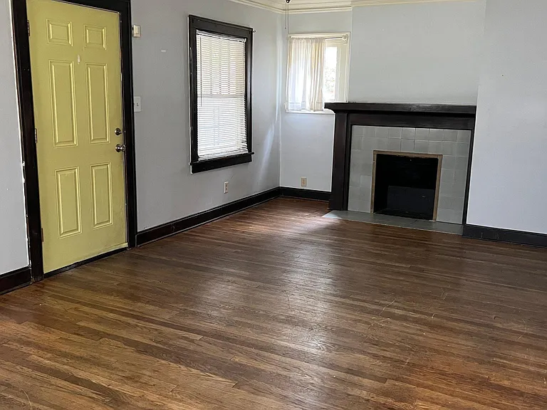 Oversized living room with fireplace and beautiful hardwood floors.