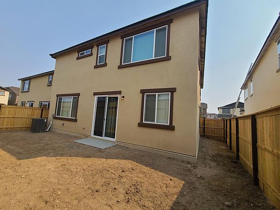 Backyard is no longer covered in dirt. Has concrete and artificial turf