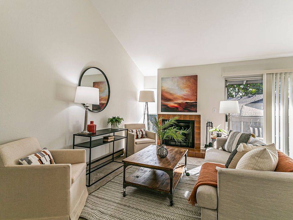 Living room with vaulted ceilngs and fireplace.