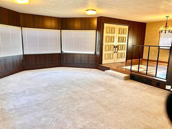 Large sunken living room on the main floor with view of dining room. Views of wheatfield from front, back and side windows.