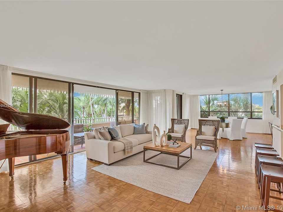 Living and Dining Rooms with Views of Tree Tops and Marina