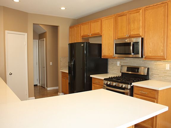 Beautiful quartz counters and glass tile backsplash. Fridge included
