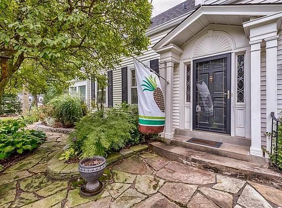 A welcoming covered front door with detailed woodwork and columns