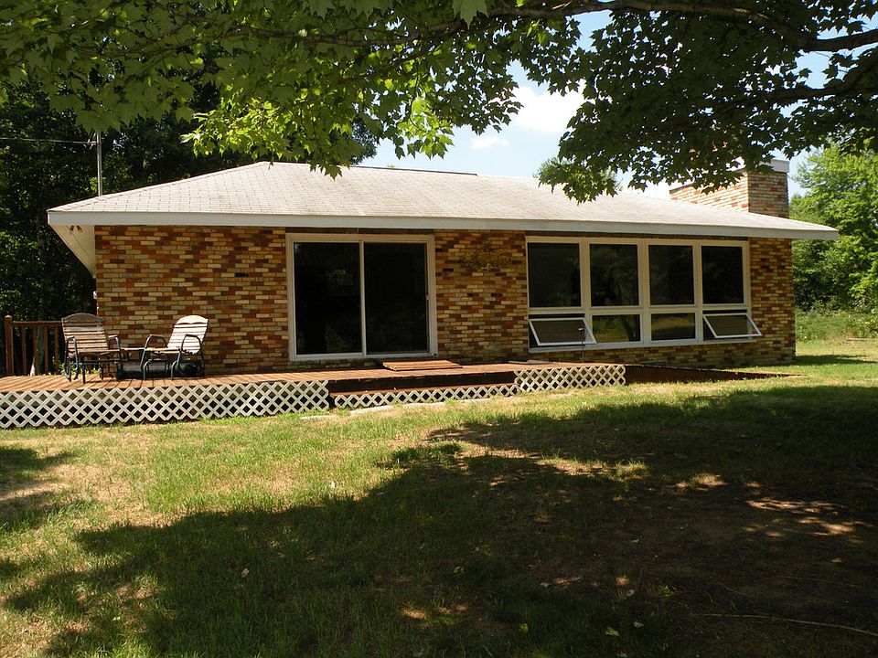 Enjoy your privacy in this home located on over 5 acres, on a beautiful surveyed 5.5 acre parcel. The views from the dining room and living room, will have you just enjoying the time that you have in the evening watching the outdoor life. Three bedroom, 2 bath ranch, with a full  walk out basement. Main floor laundry, in the mud room. HWH new 2014, new carpet, vinyl flooring and paint. Great views from inside the home. Detached garage/outbuilding. Newer electrical. Freshly stained deck. Garage has 220 power, work benches, and cement floor. Concord grapes, Blueberry bushes, and 2 apple trees. Plenty of space to start your own mini farm.