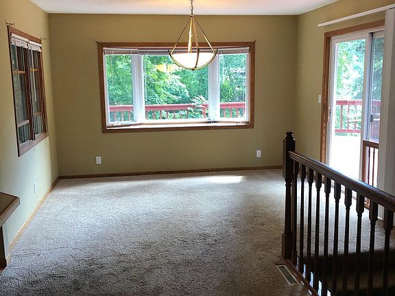 Sunny dining area with sliding glass door to deck