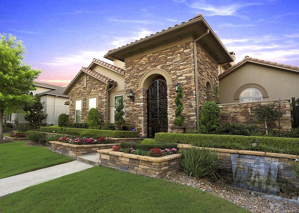Stunning CUSTOM home with extensive landscape, water feature and private courtyard entry.