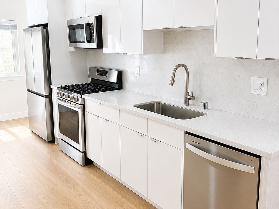 Bright kitchen and dining area with natural light, updated flooring, and clean modern finishes.