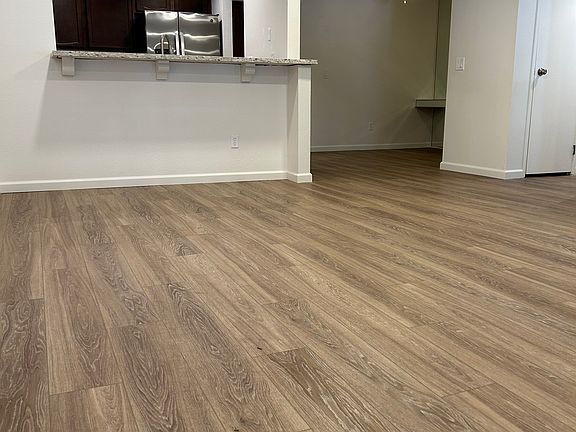Living room facing kitchen, and dining area