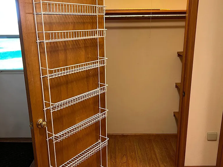 Walk-in Pantry. Shelves both sides, hanging rod and shelves on door