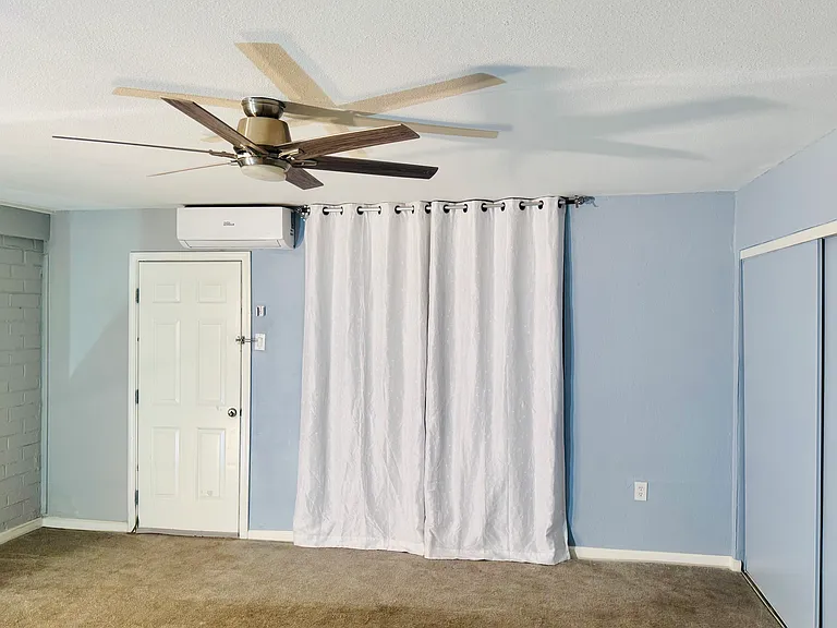 Beautiful large bedroom with walk-in closet mirror beautiful curtains. There's also a full-size washer dryer and a side door to go out if needed