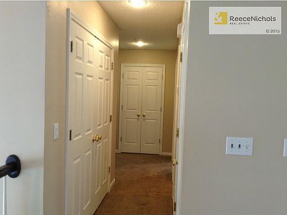 Hallway leading to the three upstairs bedrooms.  Laundry in the