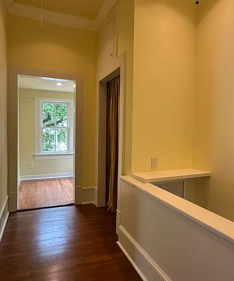 The stair hall has a draped storage closet.