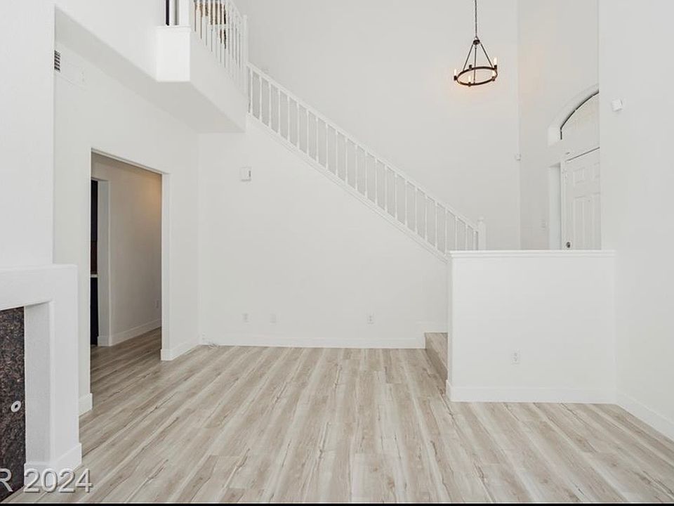 entryway, living room with fireplace and backyard access