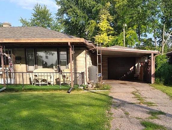 Carport leads to garage