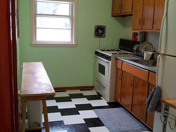Kitchen has gas stove with griddle and new floor.